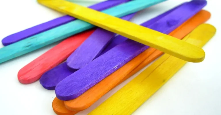 Bright turquoise, red, purple, orange, and yellow stained wood craft sticks fanned out
