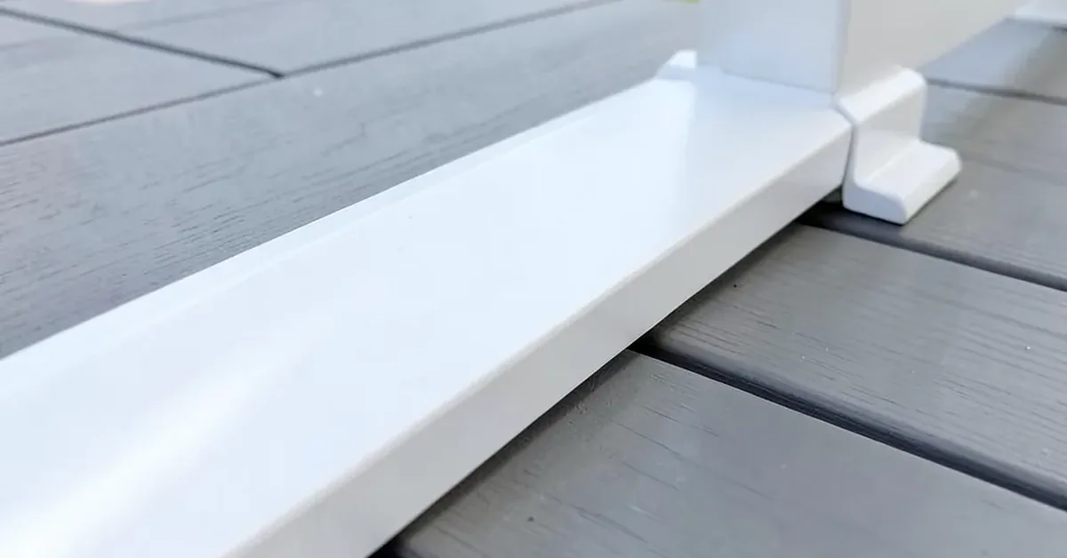 White composite fascia trim board along the edge of a gray composite deck