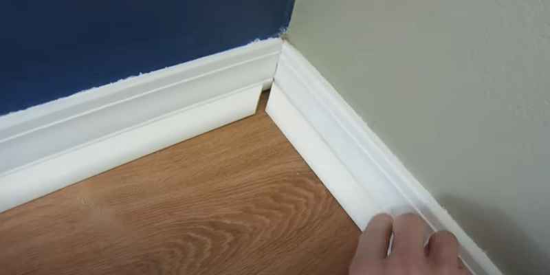 Quarter round molding coped and fitted at an inside 90-degree corner over laminate flooring