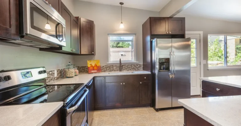 Dark wood kitchen cabinets paired with light quartz countertops
