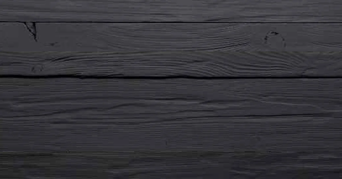 Wood planks dyed black showing an even, grain-visible finish