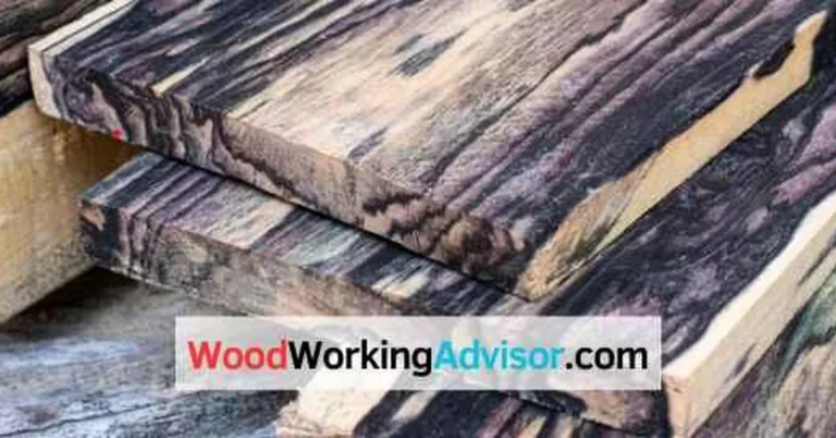 Stacked ebony wood boards with the dark, striped grain typical of Gaboon and Macassar ebony
