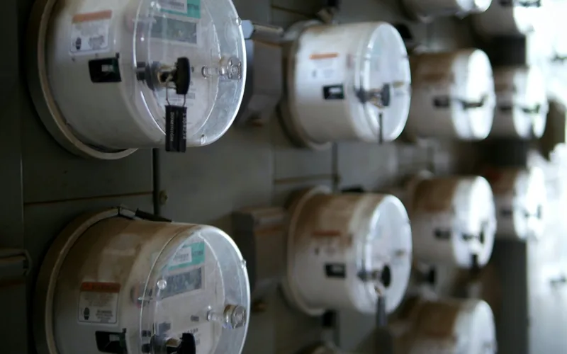 bank of electric utility meters measuring current draw bank of electric utility meters measuring current draw