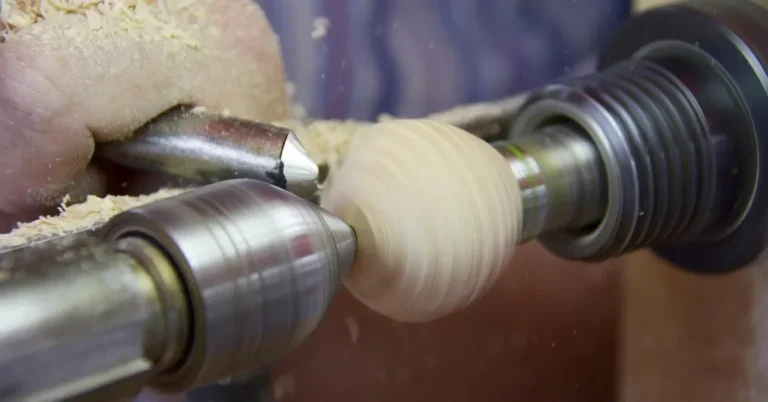 Live center of a wood lathe supporting a small spindle blank being turned