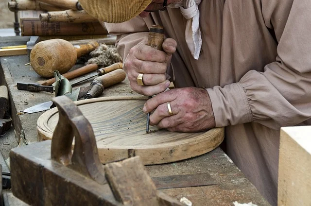 Woodworker hand-carving a soft, fine-grained wood similar to horse chestnut