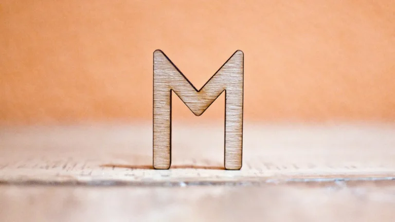 Laser-cut thin plywood letter showing the layered veneer edge