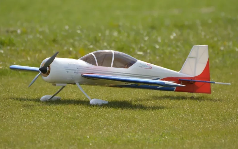 Model airplane built for low weight Radio controlled model airplane resting on grass