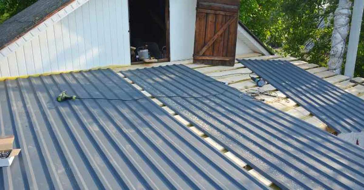 Installing metal roofing panels on a pole-barn-style building