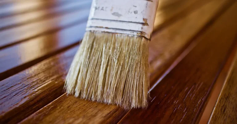 Brush applying finish to wood after cleaning with mineral spirits