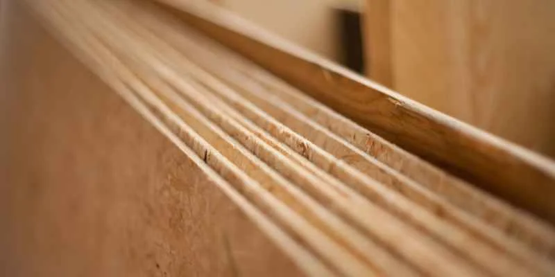 Close-up of cross-laminated plywood edge showing individual veneer layers