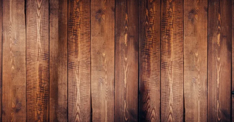 Dark stained hardwood floor planks with visible grain, a sealed and dry floor