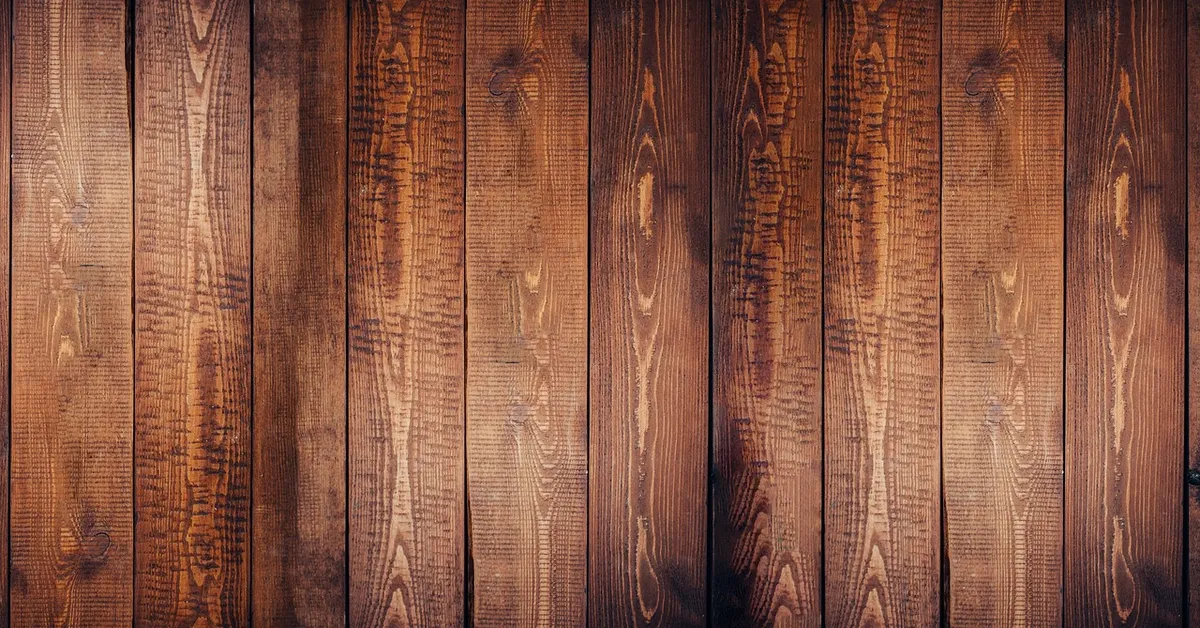 Dark stained hardwood floor planks with visible grain, a sealed and dry floor