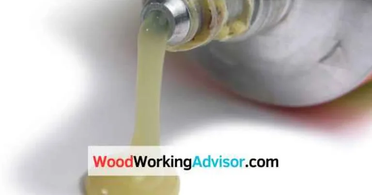 Bottle of clear adhesive dispensing a drop, used to illustrate super glue removal