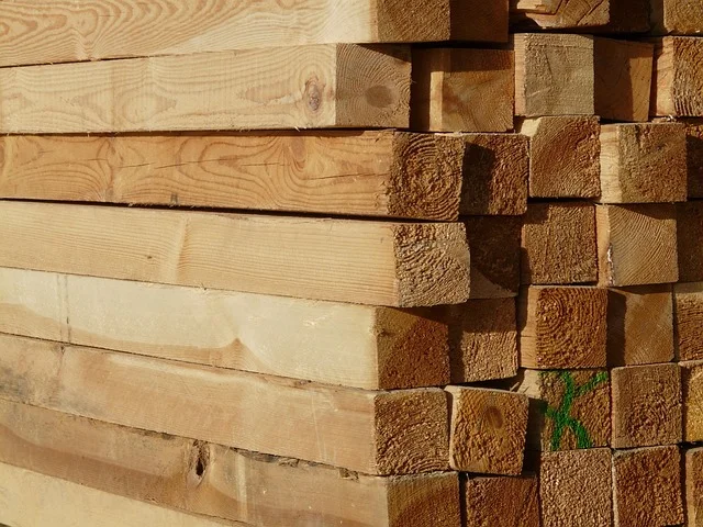 Stack of kiln-dried whitewood lumber boards showing light, consistent grain