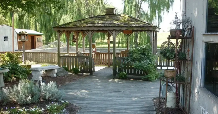 weathered grey wood deck leading to a backyard gazebo