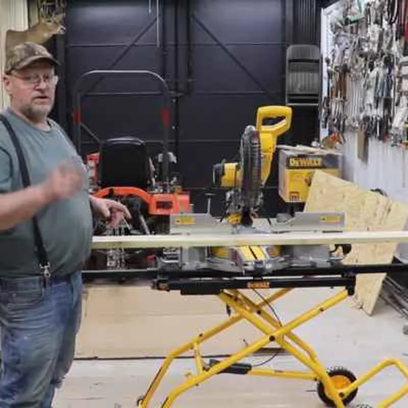 Close-up of a Shop Fox table saw blade, riving knife, and cast-iron table surface