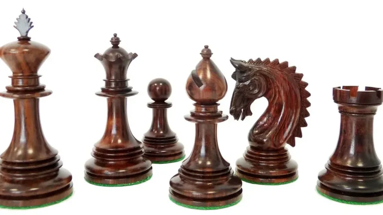 Set of turned chess pieces made from dense reddish-brown hardwood