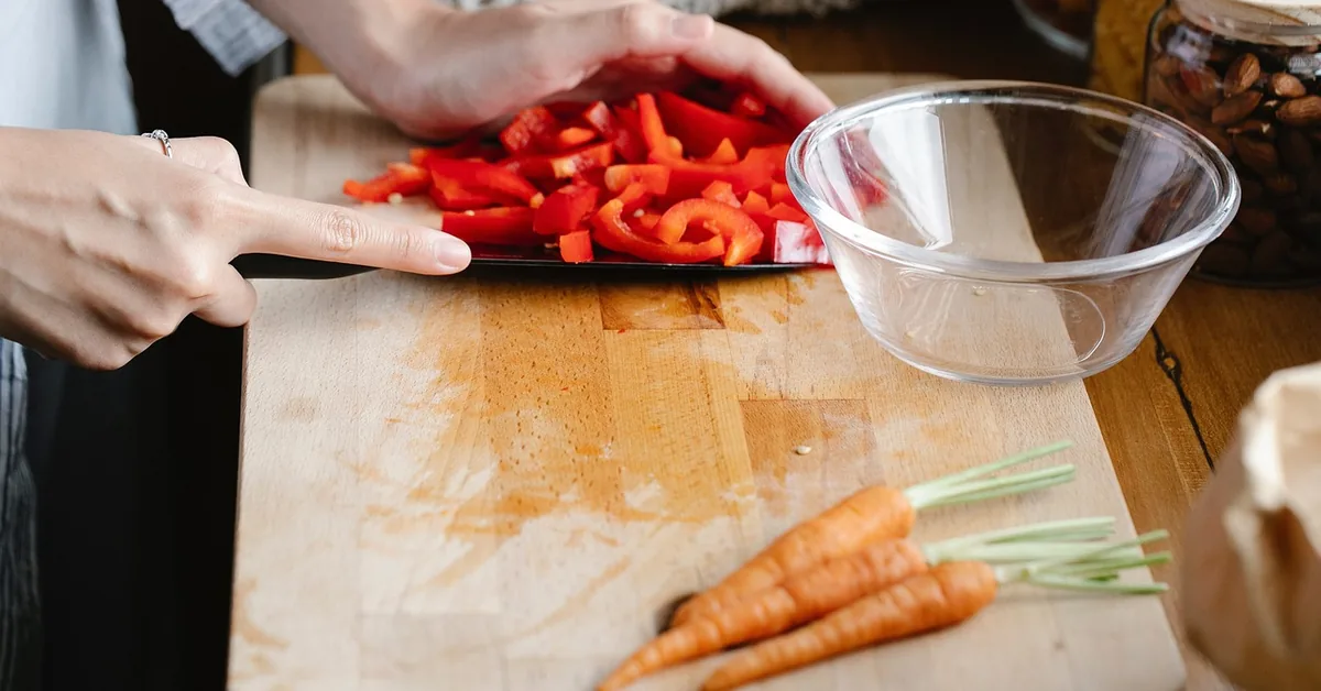 fresh vegetables being prepped on a wood cutting board in a kitchen fresh vegetables being prepped on a wood cutting board in a kitchen