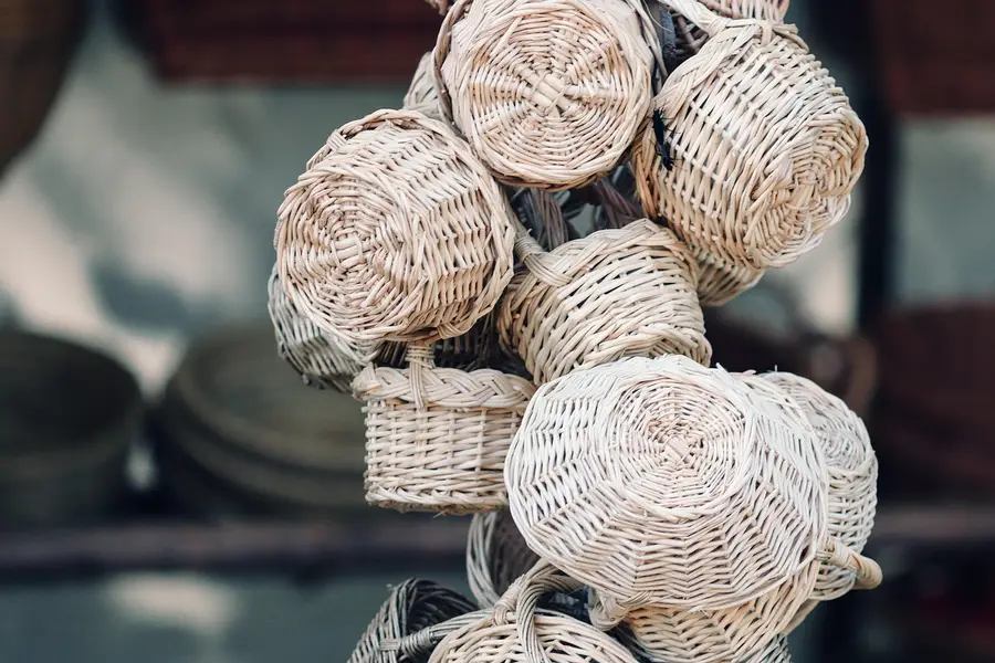 Woven willow baskets hanging in a market stall