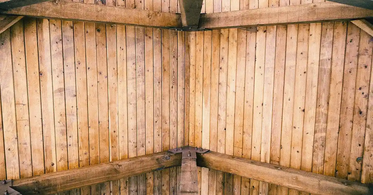 Wood ceiling with exposed beams before sealing
