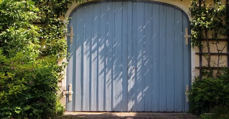 Wooden garage door with vertical plank construction before restaining