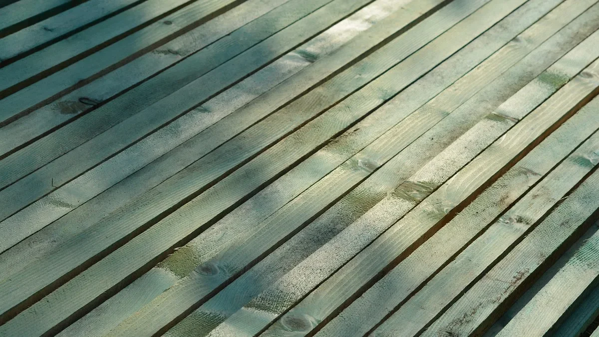 Row of wood lath strips laid side by side with narrow gaps between them