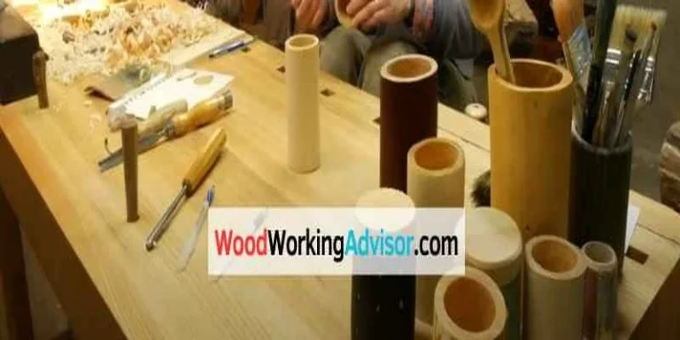 Woodworker turning wood cylinders on a bench, shavings piled from moisture loss driving wood shrinkage