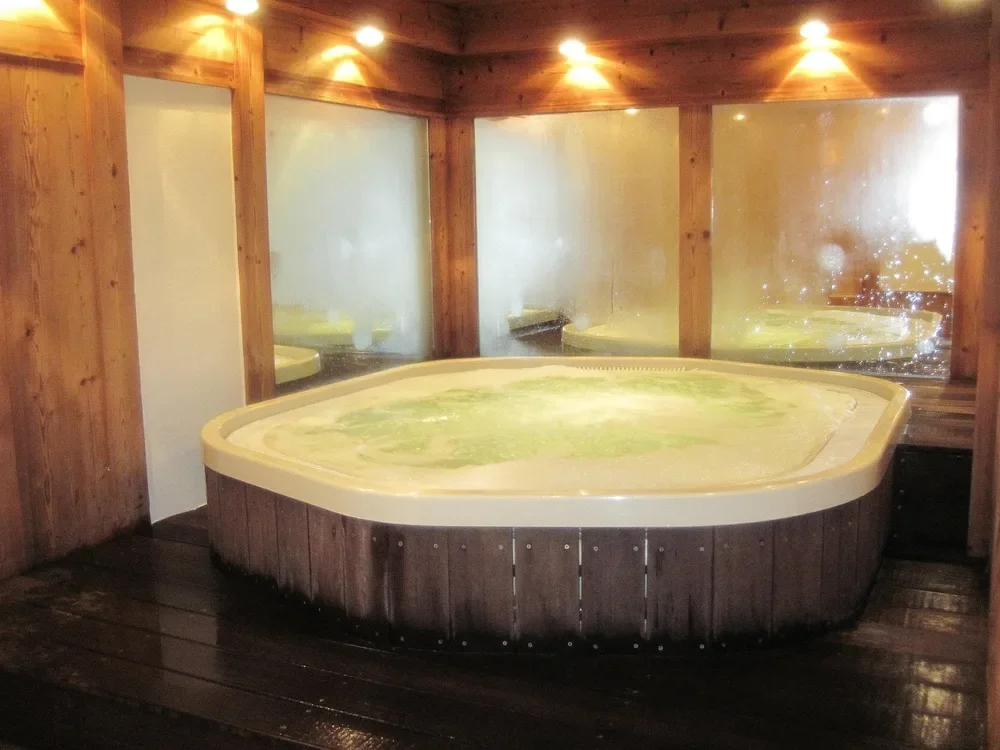 Wood-clad spa tub in a wood-paneled room