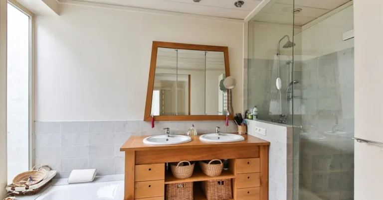 Solid wood bathroom vanity with two sinks under a wood-framed mirror