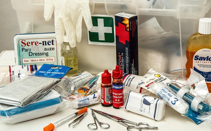 A stocked first aid kit with bandages and antiseptic for treating shop injuries