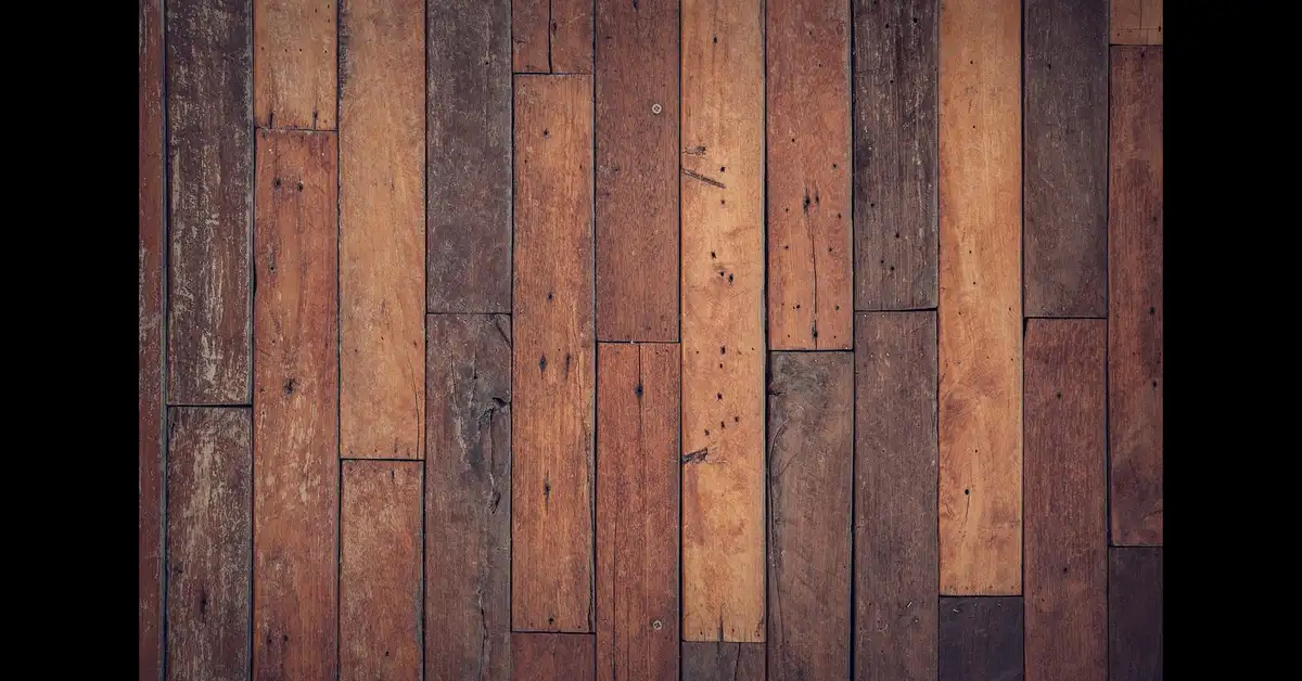 Worn hardwood floor planks showing scratches and dull finish before refinishing