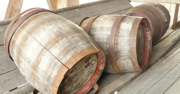 Old wooden barrels with curved staves held by metal hoops