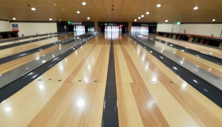 Close-up of a polished wood bowling alley lane showing alternating maple and pine strips