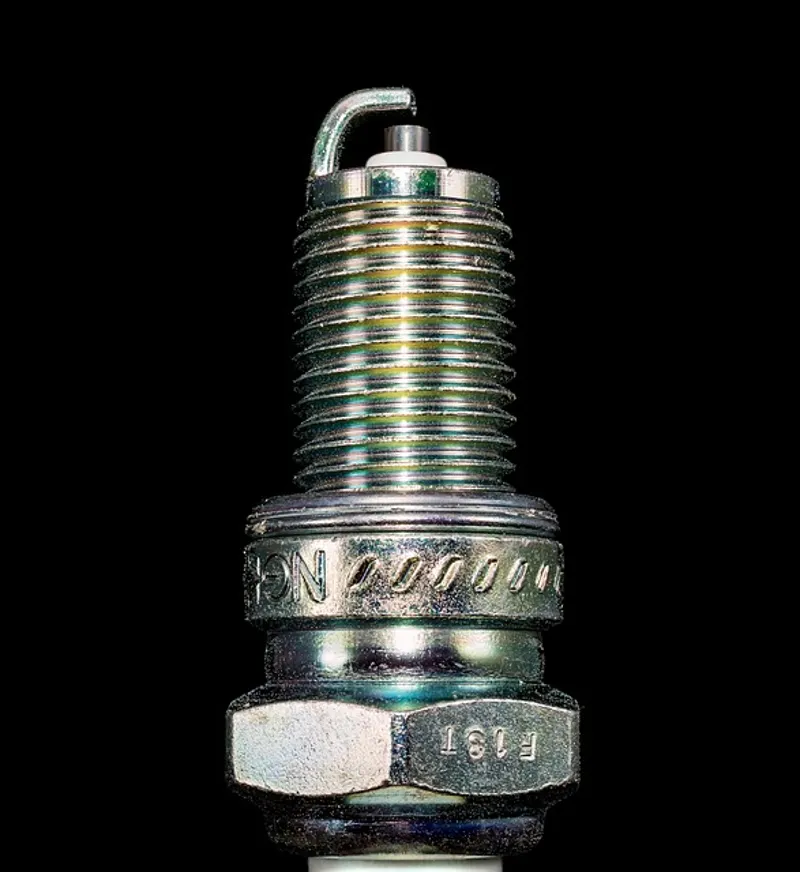Close-up of a chainsaw spark plug, a common ignition component to inspect