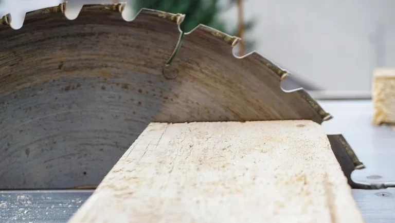 Circular saw cutting through a wood board with sawdust flying