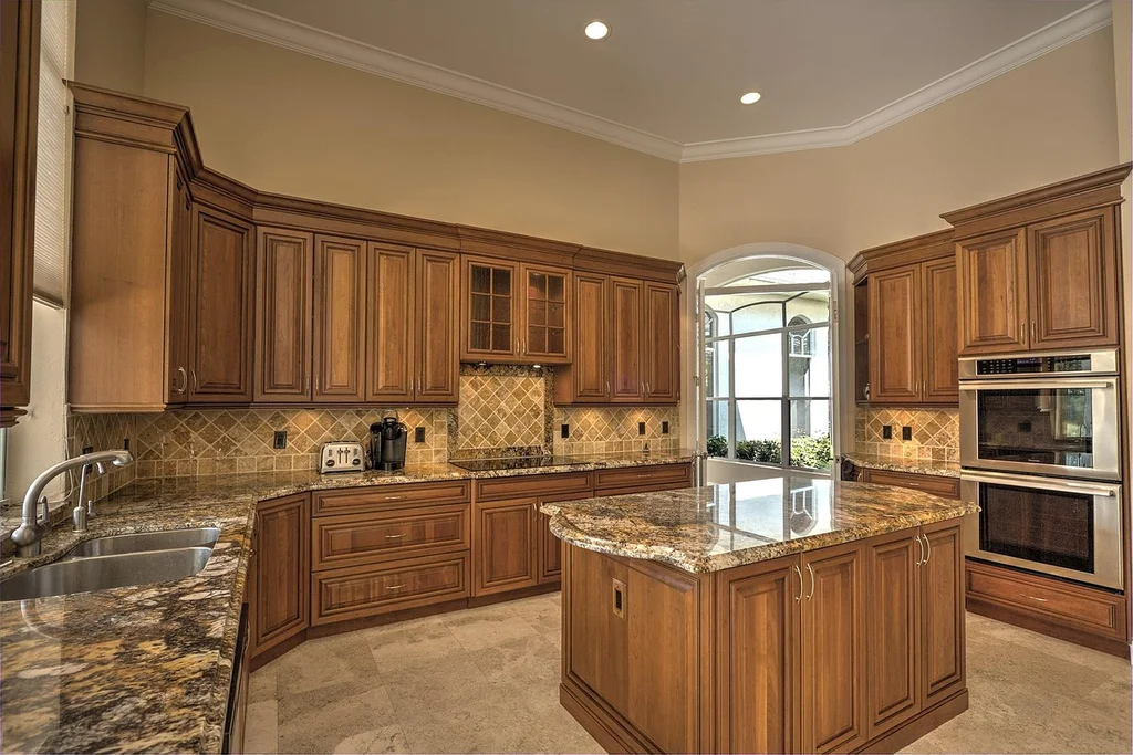 Warm-toned traditional wood kitchen cabinets with raised panel doors