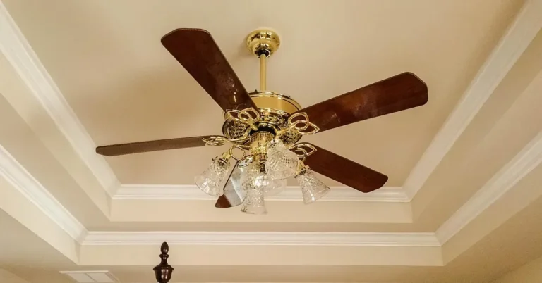 White crown molding with mitered corners around a tray ceiling