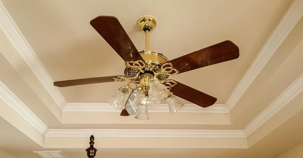 White crown molding with mitered corners around a tray ceiling