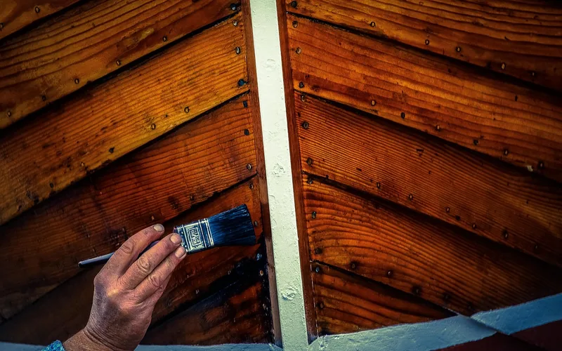 Curved wooden hull planking on a boat bow showing successfully bent wood strakes