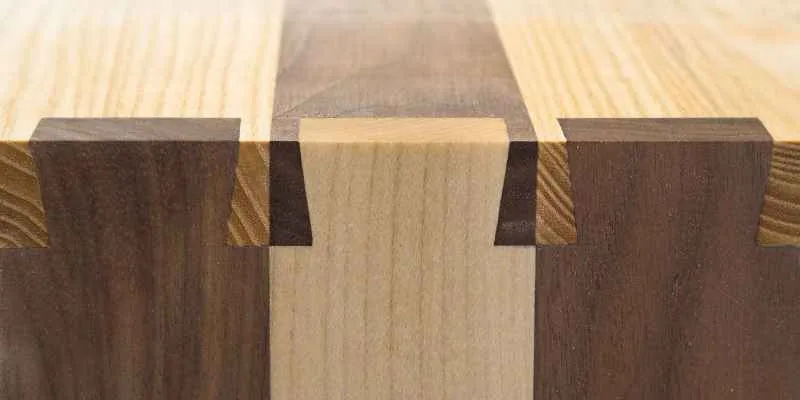 Dovetail joint in contrasting walnut and maple wood before glue-up