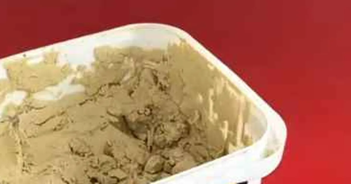 dried, crumbly wood filler with a hardened crust inside an open tub dried, crumbly wood filler with a hardened crust inside an open tub