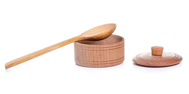 A finished wooden lid with a turned knob on a small jar