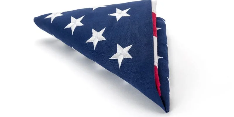 Close-up of a folded flag showing only the blue field of stars visible, no red or white showing