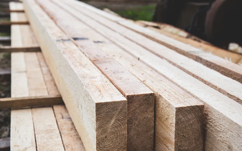 freshly sawn rough cut lumber planks stacked at a lumber yard