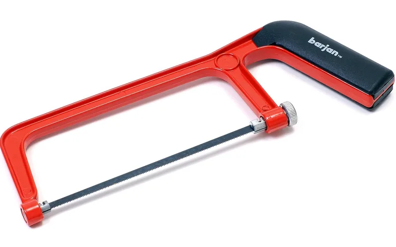 hacksaw cutting through metal pipe clamped in a vise hacksaw cutting through metal pipe clamped in a vise