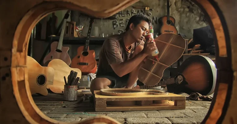 Luthier applying hide glue during guitar body repair, the traditional use case for a Hold Heet glue pot