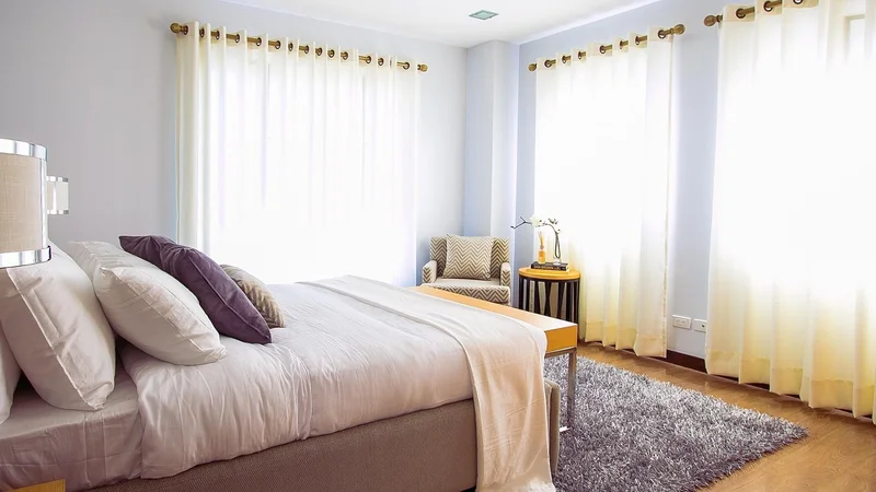 Bedroom with a low-profile bed frame supporting a mattress and box spring