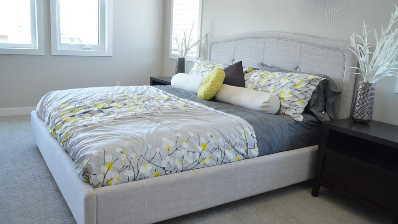 Bed with an upholstered headboard attached, no footboard, typical Hollywood bed frame style