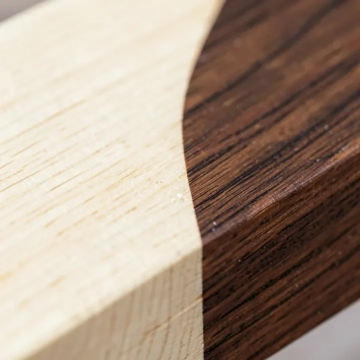 Close-up of raw black walnut lumber showing the contrast between pale sapwood and dark brown heartwood