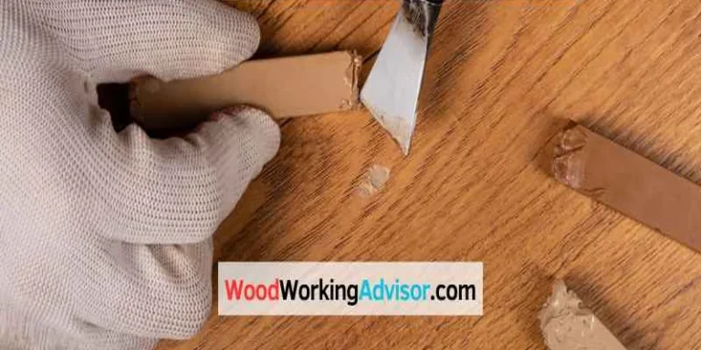 Filling a deep scratch in wood furniture with a putty knife